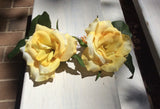 Matching pair of yellow Hair flowers on combs